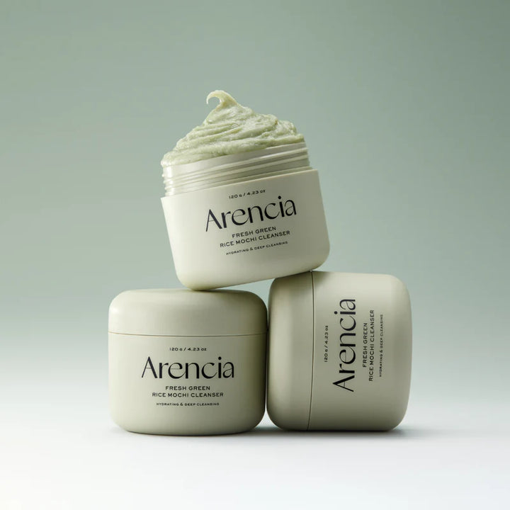 Arencia Fresh Green Rice Mochi Cleanser in a clear bottle, showcasing its vibrant green rice-based liquid for gentle facial cleansing.