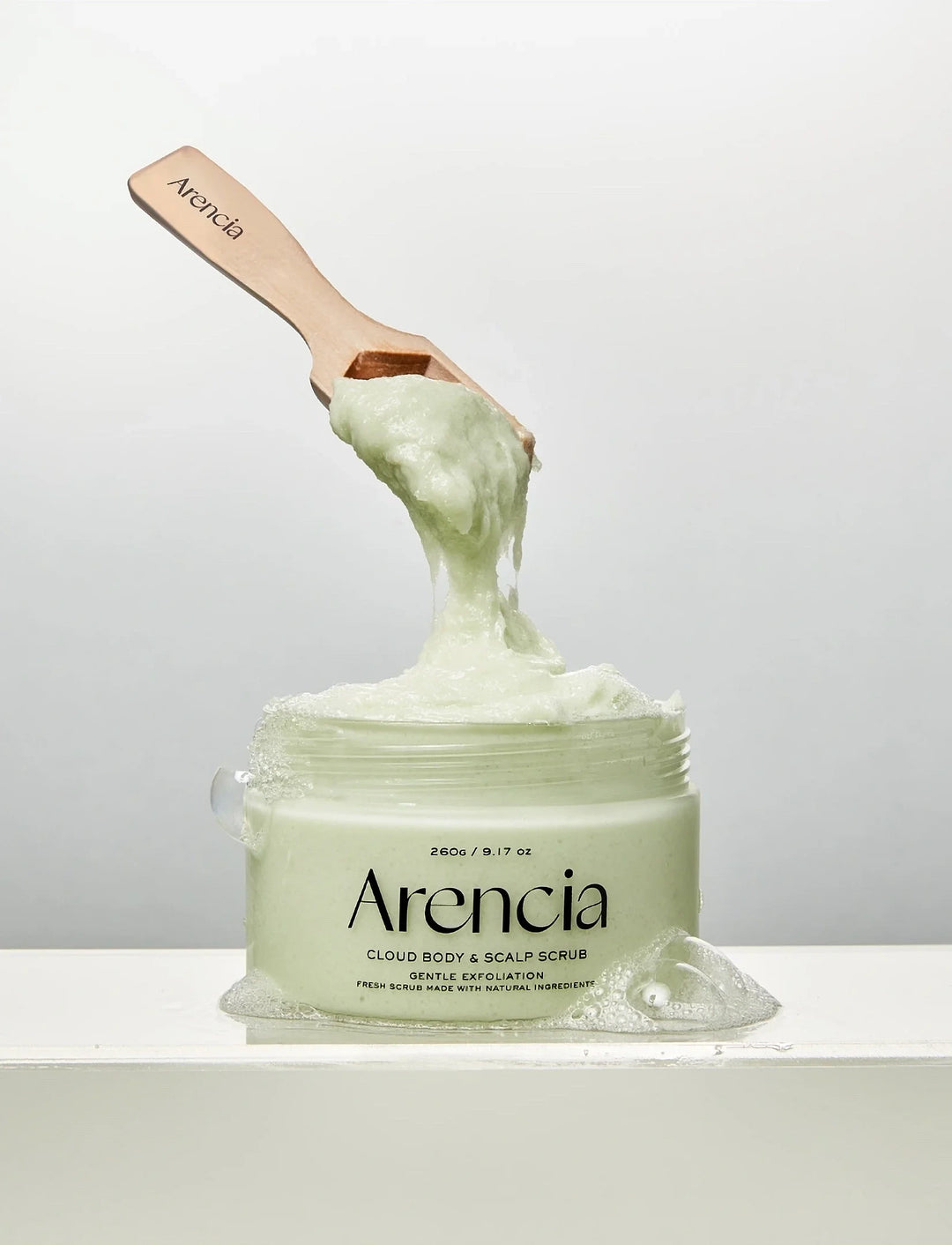 Arencia Fresh Cloud Body & Scalp Scrub with geranium and primrose, showing the exfoliating scrub in a sleek jar.