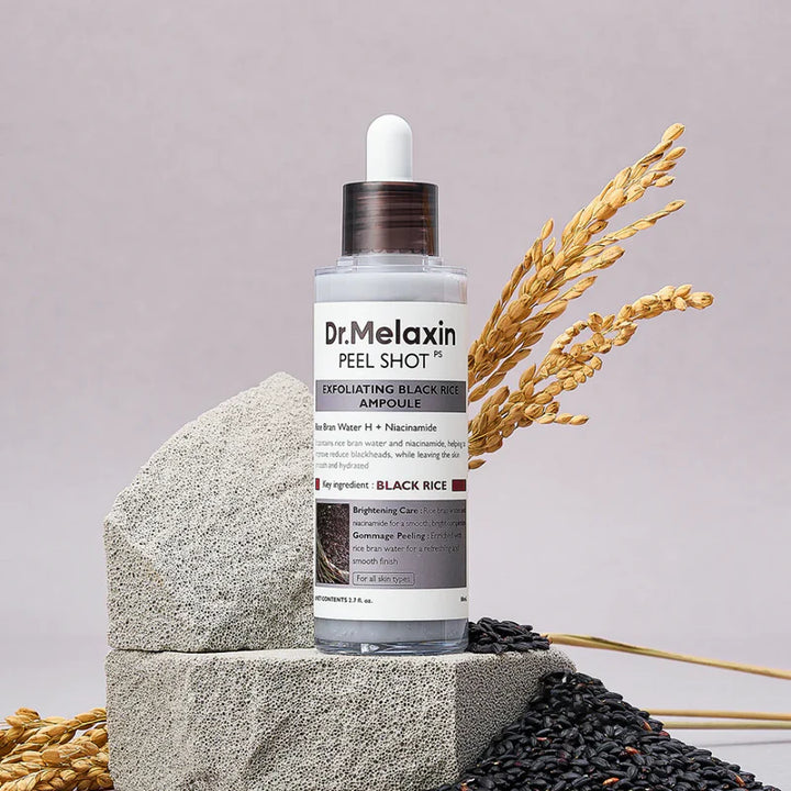 Dr. Melaxin Black Rice Peel Shot Exfoliating Serum in 80ml bottle, featuring black rice extract for skin renewal and brightening.