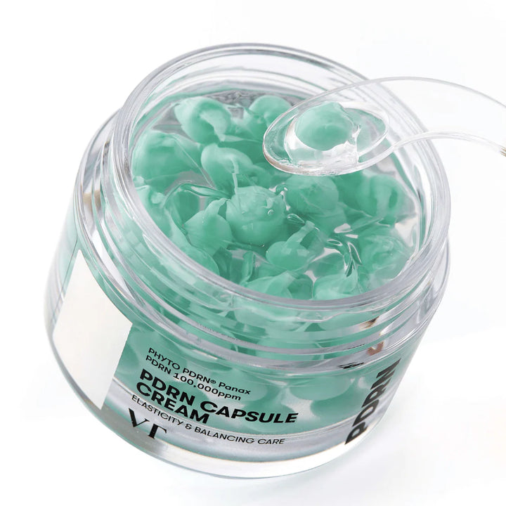 VT Cosmetics PDRN Capsule Cream 100 in a clear jar, showcasing the cream's smooth texture and capsule-infused formula.