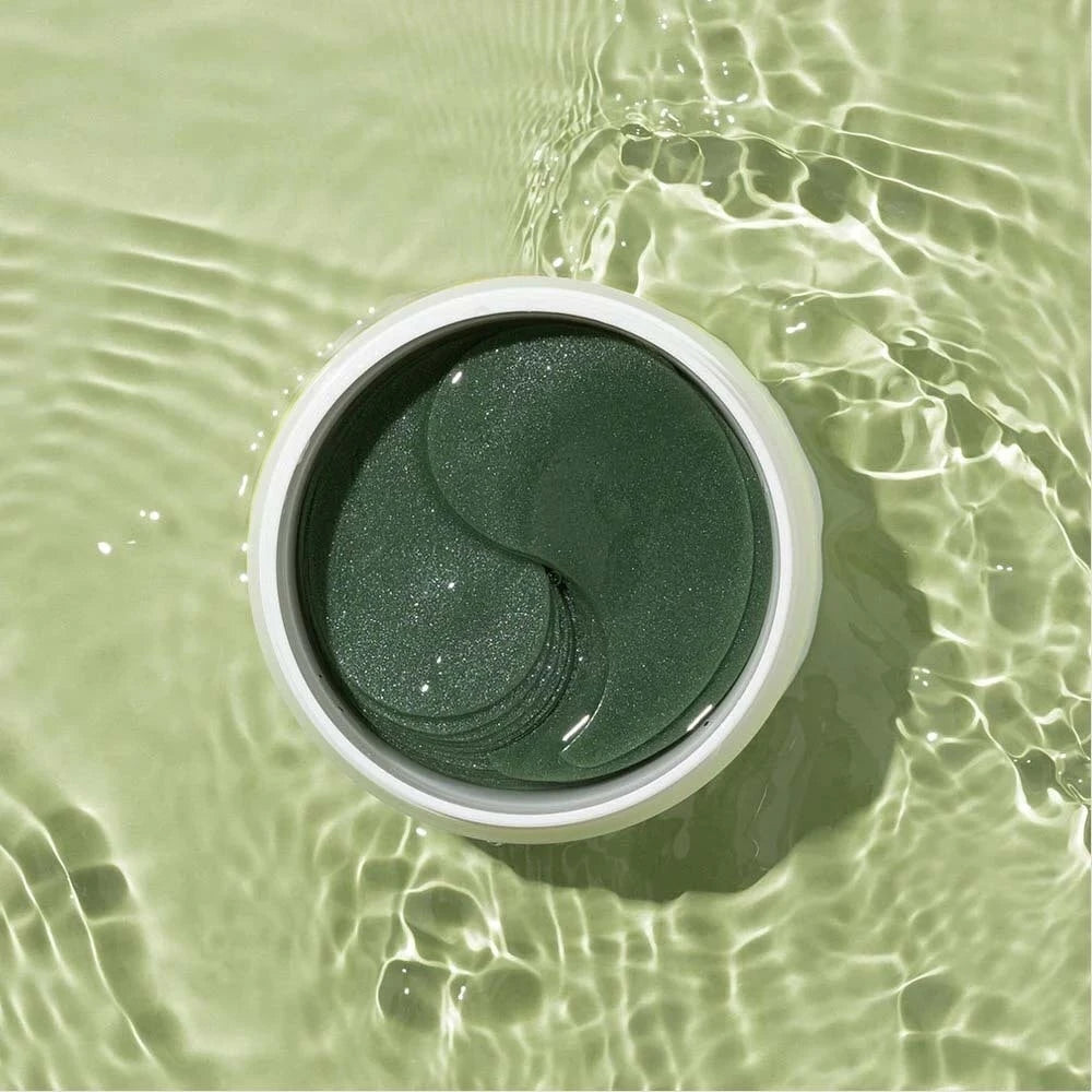 Heimish Matcha Biome hydrogel eye patches shown on skin, designed to reduce puffiness and dark circles around the eyes.