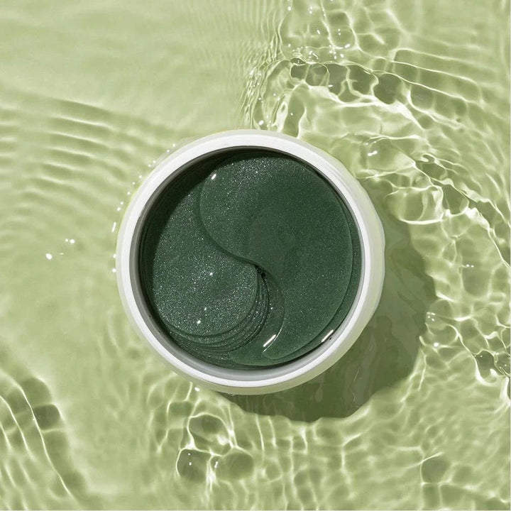 Heimish Matcha Biome hydrogel eye patches shown on skin, designed to reduce puffiness and dark circles around the eyes.